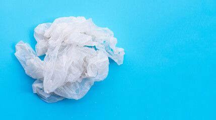 Fototapeta premium Crumpled plastic bags on blue background. Copy space