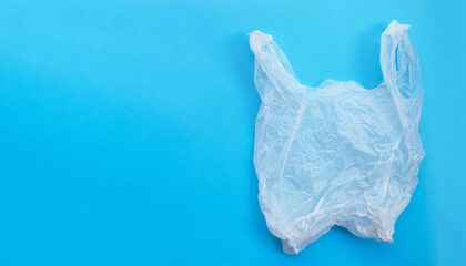 Fototapeta premium White plastic bag on blue background. Copy space