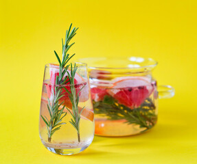 freshly squeezed juice with pieces of grapefruit and rosemary