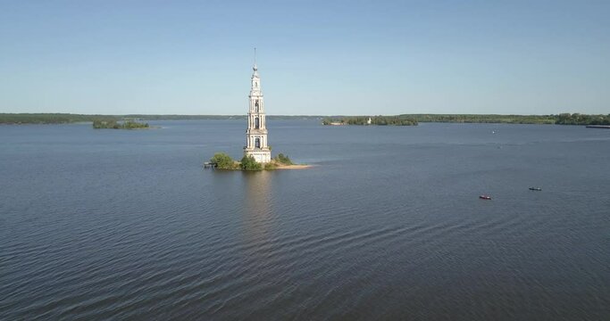 4K high quality aerial video footage of partly submerged Nikolskiy/St. Nicholas Сathedral bell tower off the shore Kalyazin town on great Volga River, Golden Ring route 200 km from Moscow, Russia