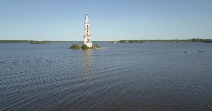 4K high quality aerial video footage of partly submerged Nikolskiy/St. Nicholas Сathedral bell tower off the shore Kalyazin town on great Volga River, Golden Ring route 200 km from Moscow, Russia