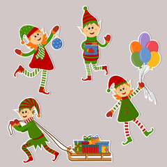 Naklejka premium Set of isolated Christmas elf stickers for girls and boys with gifts, balloons and Christmas toys. Color vector illustration in flat style. Clipart, stickers, design, decoration