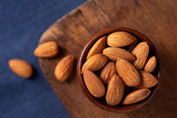 Overhead view of whole raw almonds with copy space