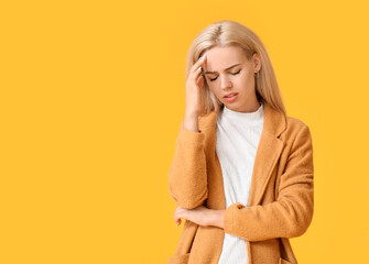Stressed young woman on color background
