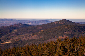 top of mountain peak at sunset light. awersome clear view with hills and deep blue sky landscape