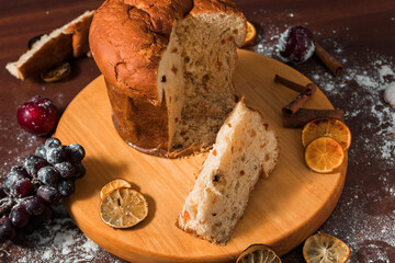 Traditional Christmas panettone with dried fruits on rustic background. Panettone is the traditional Italian dessert for Christmas