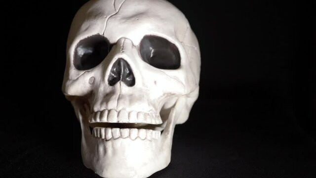 Human skull on dark background with lightening storm effect