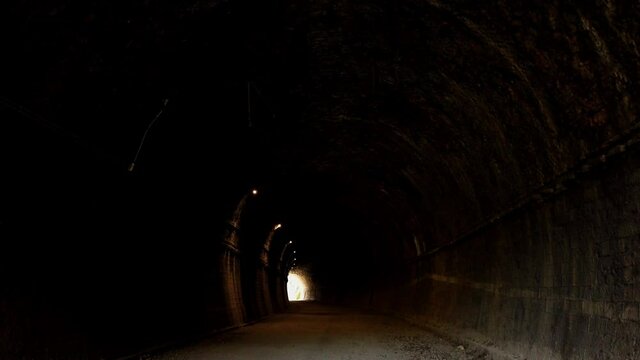 Pedonal tunnel that was once built for a railway. Located in the Gorges of the Nera River in the outskirts of Narni in Umbria, central Italy. Dolly motion.