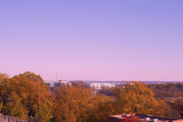 Washington DC panorama with Potomac River at sunset. Colorful autumn colors in Georgetown neighborhood under clear sunset skies.