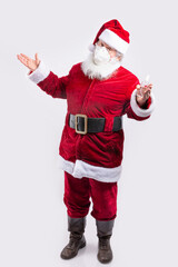 Santa Claus wearing a mask, with botlte of hydroalcoholic gel in white background