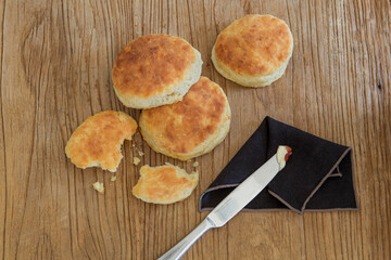 Homemade biscuits with jam and butter on a knife