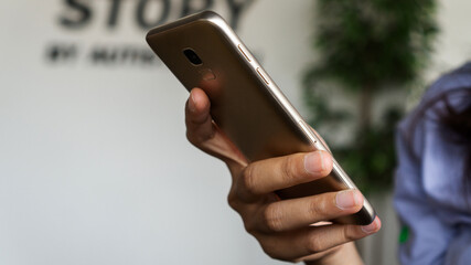 Hand holding smart phone with blank copy space.