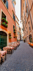 Beautiful classic street of Rome with Open Air Restaurants in summer season, Italy
