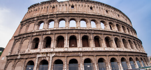 Fototapeta premium The Colosseum and the homonymous square on a summer day, Rome, Italy