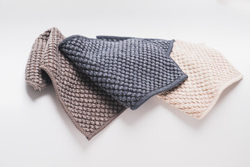 3 small kitchen towels, with recycled material in light brown, dark brown, and dark blue color. On the white background surface