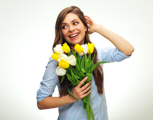 Smiling happy woman  holding yellow flowers and looking away.