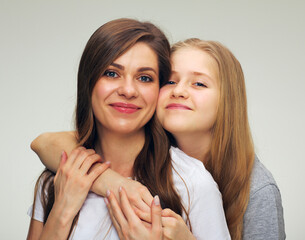 Daughter hugs his mother isolated studio portrait