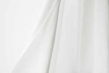 Fototapeta na wymiar Flowing white curtain motion textured background