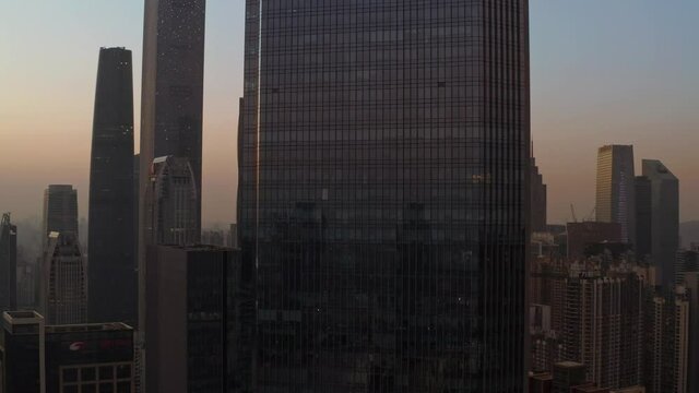 Guangzhou central buildings district on colorful sunset. Aerial shot. Dolly right.