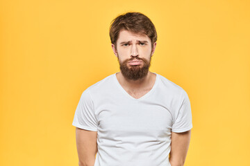 Obraz premium Bearded man emotions gestures with hands facial expression white t-shirt yellow background