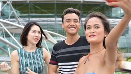Asian friends outdoor having fun visiting city
