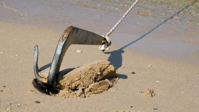 Ship's anchor stuck in the sand