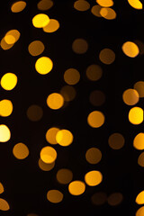 Glowing abstract background. Defocused Christmas lights. Bokeh effect. New year celebration.