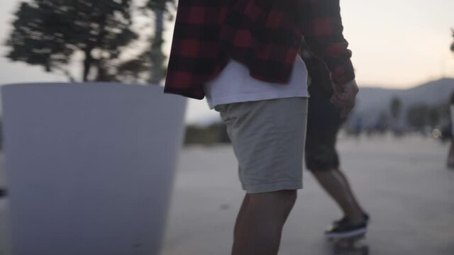 Skateboarders cruising at Gava beach Barcelona