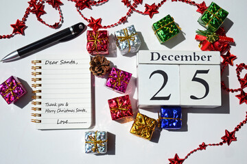Fototapeta na wymiar Image with wordings on notepad with cube block and christmas decorations background