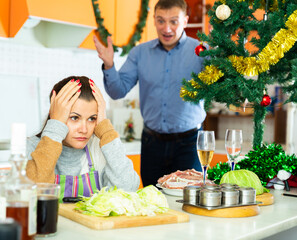 Portrait upset young woman quarreling with husband during cooking xmas dinner
