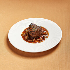Filet mignon served with mushrooms side view