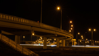 Fototapeta premium Long exposure photo of traffic on the move at night on the road