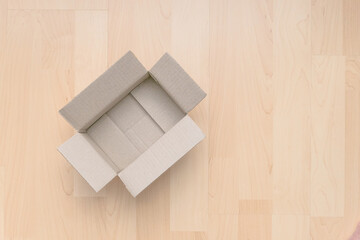 Empty open rectangular cardboard box on wood. Shopping online object background. Shipping parcel object.