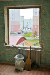 An empty opening in the wall. Photo of dismantling a window in a city apartment.