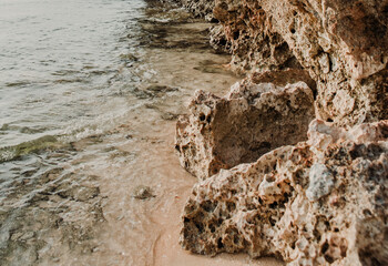 Rock with stones on the coast of the beach.