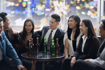 Group Of Asian Friends Enjoying Evening Drinks in bar. Celebration, Party People Christmas and Happy new year concept. Asian business people in party.