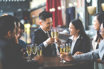 Group Of Asian Friends Enjoying Evening Drinks in bar. Celebration, Party People Christmas and Happy new year concept. Asian business people in party.