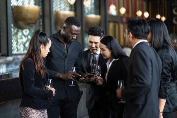 Group Of diversity business people are Friends Enjoying Evening Drinks in bar.Celebration, Party People Christmas and Happy new year concept. Asian business people in party.