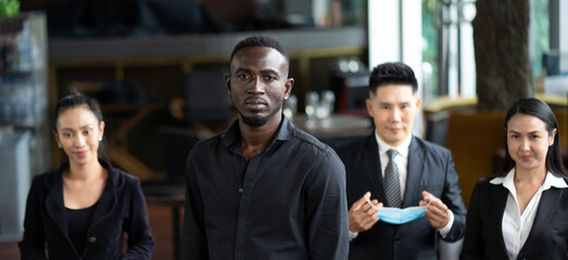 Portrait Of Business Team inside modern Office. Group of diverse business people with African American businessman leader.