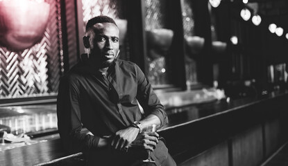 Portrait of confident African American businessman at nightclub.