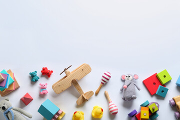Flat lay composition with different toys on white background. Space for text