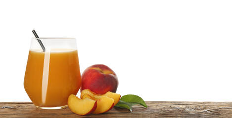 Freshly made tasty peach juice on wooden table against white background