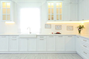 Blurred view of modern kitchen interior with stylish furniture