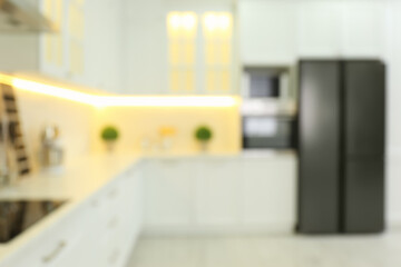 Blurred view of modern kitchen interior with stylish furniture