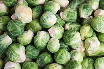 Fresh tasty Brussels sprouts as background, closeup