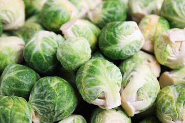 Fresh tasty Brussels sprouts as background, closeup