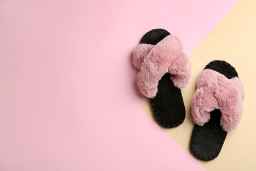 Pair of soft slippers on color background, flat lay. Space for text - obrazy, fototapety, plakaty