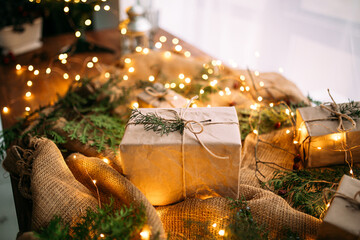 Craft gift box on the wooden table with garland