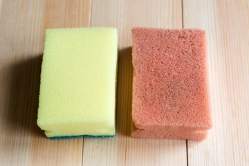 New and old dirty dish sponge on wood background.,