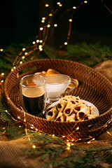 Jam cookies with coffee and milk on a basket